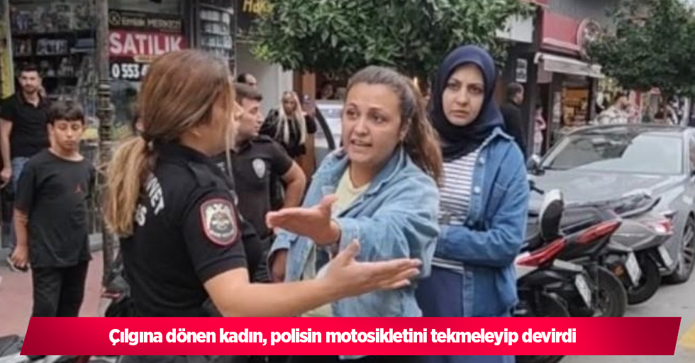 Çılgına dönen kadın, polisin motosikletini tekmeleyip devirdi